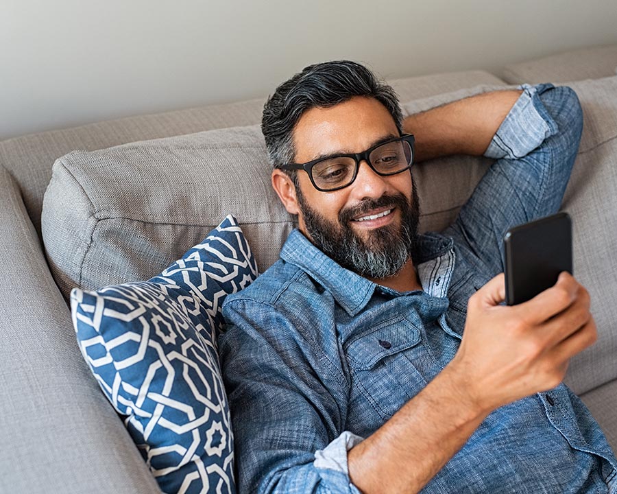 Happy smiling man using smartphone device