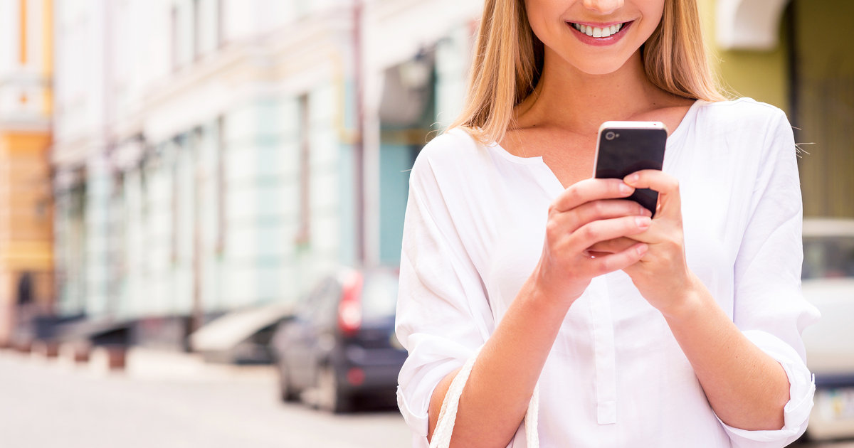 woman smiling at phone