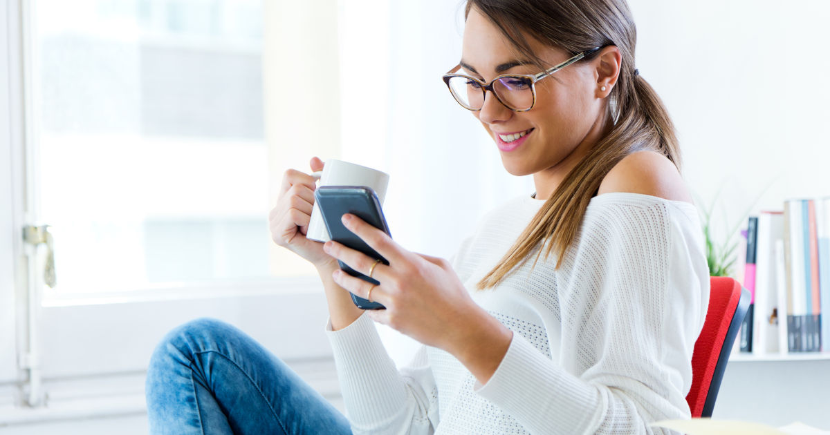 woman smiling at phone